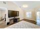 Living room with large TV, and access to bedroom at 119 Talavera Ln, Kissimmee, FL 34758