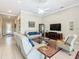Open-concept living room with comfortable seating, a large TV, and views of the entryway at 678 Irvine Ranch Rd, Kissimmee, FL 34759