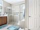 Walk-in shower with glass enclosure and built-in seat at 678 Irvine Ranch Rd, Kissimmee, FL 34759