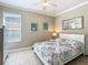 Guest bedroom with a queen bed, window, and neutral decor at 678 Irvine Ranch Rd, Kissimmee, FL 34759