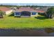 Backyard features a large screened patio and lake access at 678 Irvine Ranch Rd, Kissimmee, FL 34759