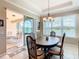 Dining room with sliding doors to a screened lanai, and views of the golf course at 678 Irvine Ranch Rd, Kissimmee, FL 34759