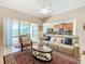 Relaxing living room with comfy seating, a large TV, and access to a screened lanai at 678 Irvine Ranch Rd, Kissimmee, FL 34759