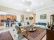Open living room featuring a neutral color palette, comfortable seating, and access to the kitchen at 678 Irvine Ranch Rd, Kissimmee, FL 34759