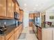 Modern kitchen with granite countertops, stainless steel appliances, and wood cabinets at 678 Irvine Ranch Rd, Kissimmee, FL 34759