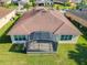 Property features a large screened patio, and a backyard overlooking a lake at 678 Irvine Ranch Rd, Kissimmee, FL 34759