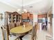 Spacious dining area with an oval table, chairs, and views into the kitchen at 678 Irvine Ranch Rd, Kissimmee, FL 34759