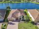An aerial view of a single-Gathering home with a two-car garage, situated in a quiet community at 678 Irvine Ranch Rd, Kissimmee, FL 34759
