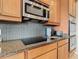 Kitchen boasts granite countertops, stainless steel appliances, and a kitchen island at 678 Irvine Ranch Rd, Kissimmee, FL 34759