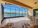 Spacious screened patio with lake view, comfortable seating and natural light at 678 Irvine Ranch Rd, Kissimmee, FL 34759