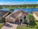 Aerial view of a house near a lake, showcasing desirable waterfront property at 678 Irvine Ranch Rd, Kissimmee, FL 34759