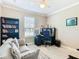 Bright home office features built-in shelving, desk, and comfortable seating at 678 Irvine Ranch Rd, Kissimmee, FL 34759