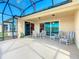 Enjoy this screened patio with lake view, comfortable seating and natural light at 678 Irvine Ranch Rd, Kissimmee, FL 34759