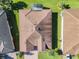 Aerial view of single-Gathering home with tile roof, and a screened enclosure at 678 Irvine Ranch Rd, Kissimmee, FL 34759