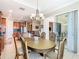 Bright dining room with an oval table, chairs, and access to a screened lanai at 678 Irvine Ranch Rd, Kissimmee, FL 34759