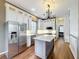 Modern kitchen with white cabinets, marble countertops, and stainless steel appliances at 307 Norfolk St, Celebration, FL 34747