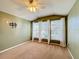 Upstairs bedroom with carpet, ceiling fan, and large windows at 307 Norfolk St, Celebration, FL 34747