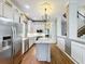 Modern kitchen with white cabinets, marble countertops, and stainless steel appliances at 307 Norfolk St, Celebration, FL 34747