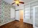 Bedroom with floral wallpaper and built-in shelving at 307 Norfolk St, Celebration, FL 34747