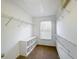 Bright walk-in closet with ample shelving and a window at 307 Norfolk St, Celebration, FL 34747