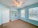 Light blue bedroom with ceiling fan and built-in shelving at 307 Norfolk St, Celebration, FL 34747