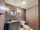 Elegant powder room with ornate mirror and dark vanity at 307 Norfolk St, Celebration, FL 34747