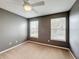 Bedroom with two windows, ceiling fan and neutral walls at 307 Norfolk St, Celebration, FL 34747