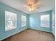 Bedroom with light blue walls, ceiling fan and two windows at 307 Norfolk St, Celebration, FL 34747