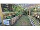 Raised garden beds with various plants under a wooden pergola at 112 10Th St, St Cloud, FL 34769