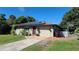 Charming tan brick home with solar panels and a spacious yard at 112 10Th St, St Cloud, FL 34769