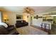 Open concept living room with view of kitchen, ceiling fan and tile floors at 112 10Th St, St Cloud, FL 34769