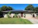 House with solar panels and a well-maintained lawn at 112 10Th St, St Cloud, FL 34769