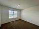 Bright bedroom with brown carpet and large window offering natural light at 1823 Veterans Dr, Kissimmee, FL 34744