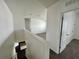 Upstairs hallway with carpet flooring and doors to bedrooms at 1823 Veterans Dr, Kissimmee, FL 34744