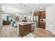 Open concept kitchen with island, stainless steel appliances, and hardwood floors at 245 Panzano Ter, Poinciana, FL 34759