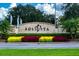 Solvita community entrance with landscaped flowerbeds and signage at 245 Panzano Ter, Poinciana, FL 34759