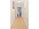 Long hallway with light walls and wood-look flooring at 4758 Wyresdale St, Orlando, FL 32808