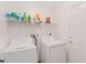 Laundry room with washer, dryer, and shelving at 4758 Wyresdale St, Orlando, FL 32808