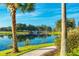 Peaceful lakeside walkway with stone bridge and lush landscaping at 795 Aviara Ln, Kissimmee, FL 34759
