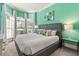 Spacious bedroom with large windows and soothing green walls at 7435 Gathering Ct, Reunion, FL 34747