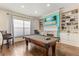 Game room with pool table, fireplace and built-in shelving at 7435 Gathering Ct, Reunion, FL 34747
