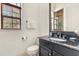 Elegant bathroom with dark vanity, granite countertop, and a large mirror at 7435 Gathering Ct, Reunion, FL 34747