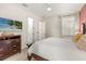 Bright bedroom with a king-size bed and large TV at 7435 Gathering Ct, Reunion, FL 34747