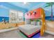 Fun bedroom with a bunk bed, beach theme, and plenty of light at 7435 Gathering Ct, Reunion, FL 34747