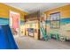 Fun ' bedroom with a themed bunk bed, slide, and mural at 7435 Gathering Ct, Reunion, FL 34747