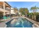 Inviting private pool with a spa, surrounded by a brick patio and lush greenery at 7435 Gathering Ct, Reunion, FL 34747
