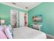 Guest bedroom with a TV and access to a walk-in closet at 7435 Gathering Ct, Reunion, FL 34747