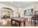 Game room with a pool table, hardwood floors and built-in shelving at 7435 Gathering Ct, Reunion, FL 34747