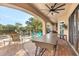 Outdoor patio with a large table, seating, and a ceiling fan at 7435 Gathering Ct, Reunion, FL 34747