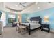 Spacious main bedroom with large windows, a comfortable bed, and plenty of natural light at 7435 Gathering Ct, Reunion, FL 34747
